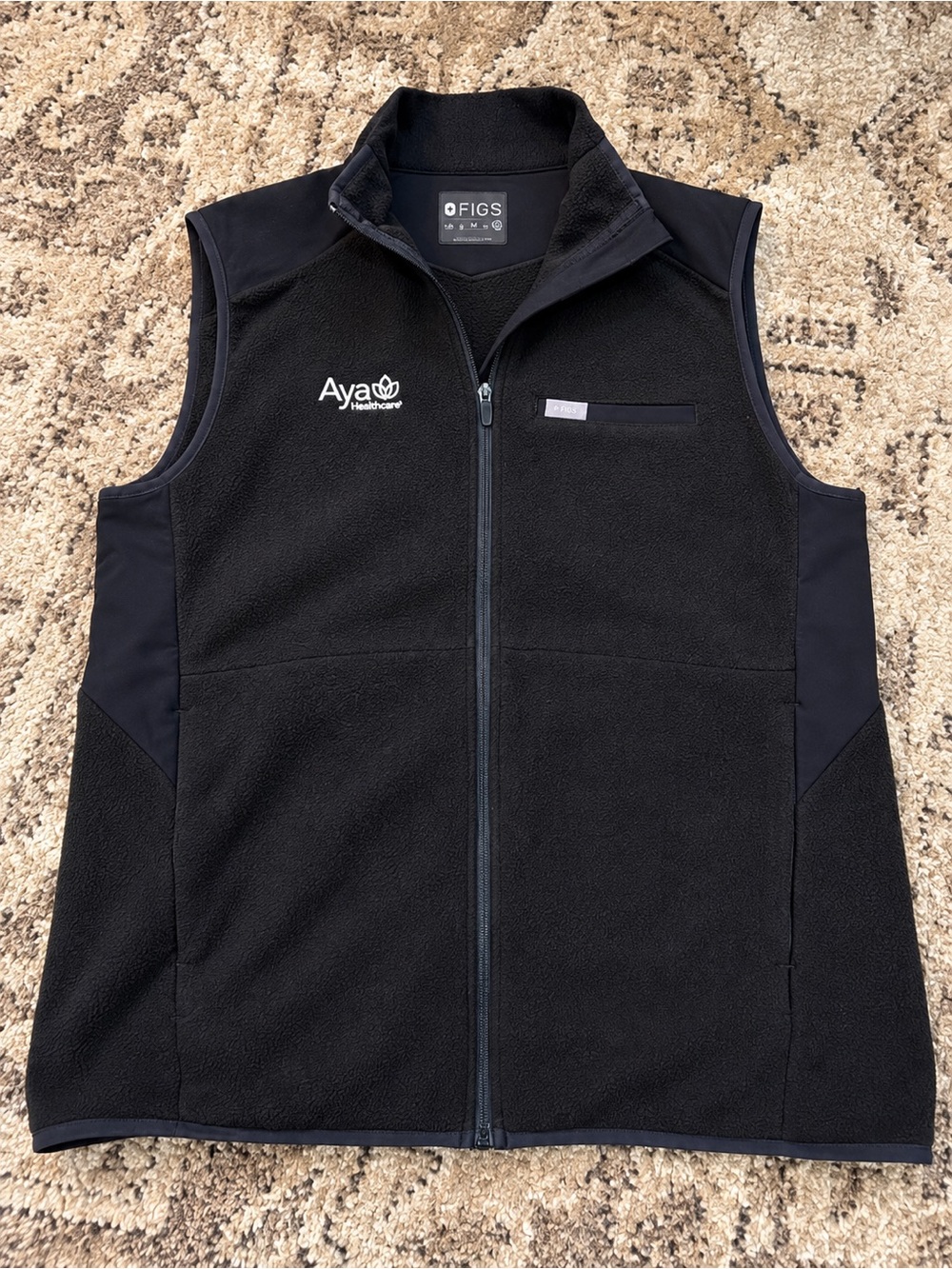 Figs Black Fleece Vest with Aya Healthcare Logo